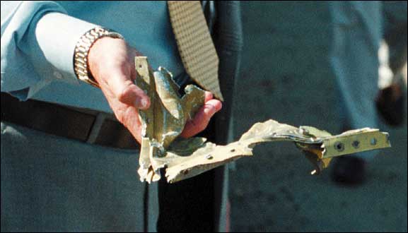 A Pentagon worker holds what is believed to be a piece of the aircraft