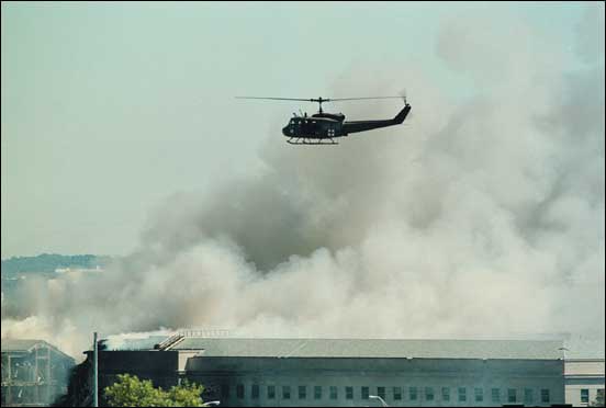 Military helicopter conducts aerial survey of Pentagon crash site.
