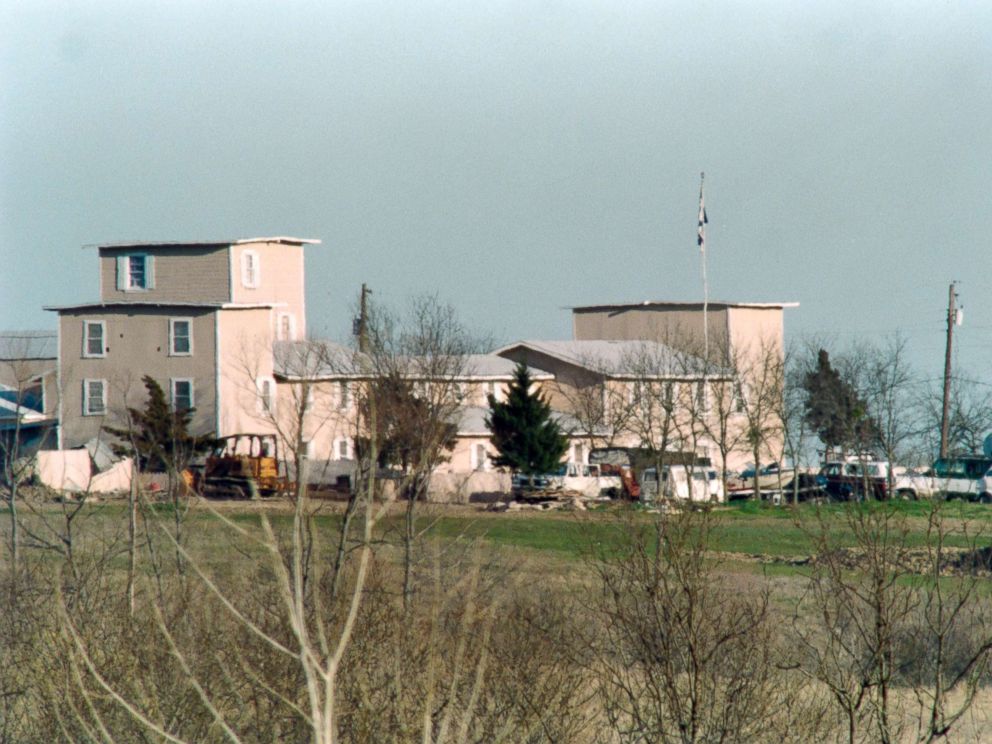 PHOTO: Various vehicles sit in front of the Branch Davidian religious compound in Waco, March 7, 1993, as the armed standoff between the religious cult and federal agents continued.